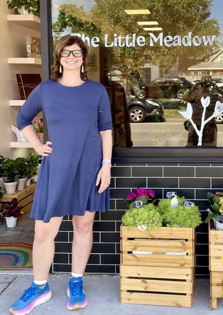 Smiling woman in front of the Little Meadow Flower Shop